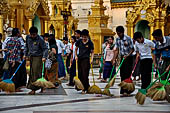 Yangon Myanmar. Shwedagon Pagoda (the Golden Stupa). Some fervent believers sweep some square meters of the pagoda, and symbolically washing their sins. 